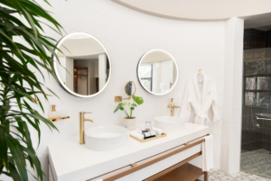 Superior King Suite hotel bathroom with two circular mirrors and under are two white circular basins.